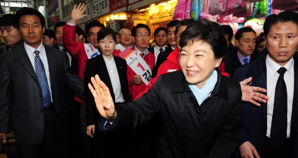 박근혜 전 대통령이 새누리당 선거대책위원장을 맡고 있던 2012년 3월  23일 대구 서문시장을 찾아 상인들을 향해 손을 들어 인사하고 있다. 뉴시스