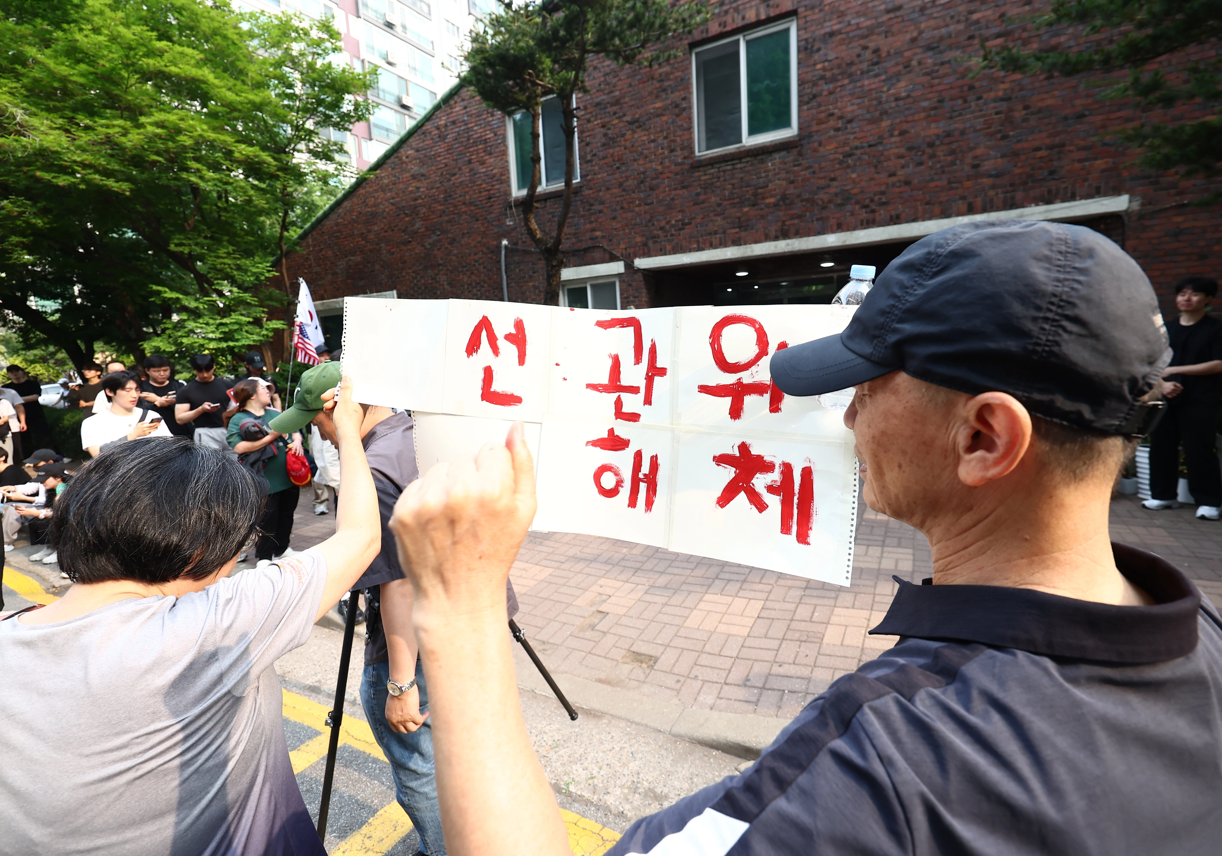 2천표 묶인 잠실 투표소 ‘대치’  4일 오전 제9회 전국동시지방선거 및 국회의원 재·보궐선거 투표함 이송이 지연되고 있는 서울 송파구 잠실7동 제2투표소에서 시위대와 일부 주민들이 선거관리위원회 해체를 외치고 있다. 2026.6.4 뉴스1