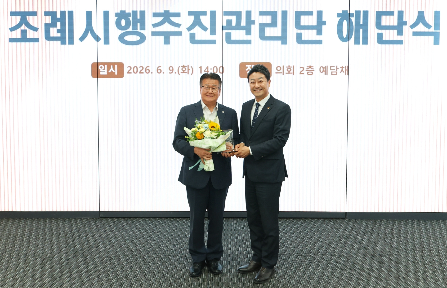 조례시행추진관리단 해단식에서 김진경 경기도의회 의장이 전국 최초로 조례 시행 점검 체계를 안착시킨 안명규 공동단장에게 감사패를 전달한 후 기념촬영을 하고 있다. (사진=경기도의회)