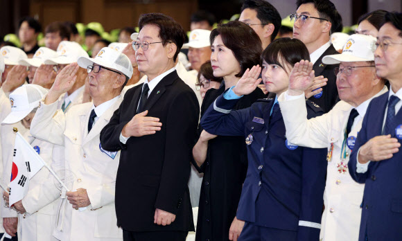 이재명 대통령과 김혜경 여사가 25일 수원컨벤션센터에서 열린 6?25전쟁 제76주년 기념식에서 국기에 경례하고 있다. 2026.6.25 연합뉴스