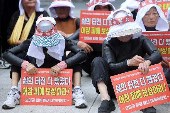 29일 서울 송파구 쌍용건설 본사 앞에서 열린 포항시 남구 호미곶항 정비공사로 인한 해녀피해 보상 촉구 집회에서 참가자들이 발언을 들으며 생각에 잠겨 있다. 2026.6.29  연합뉴스