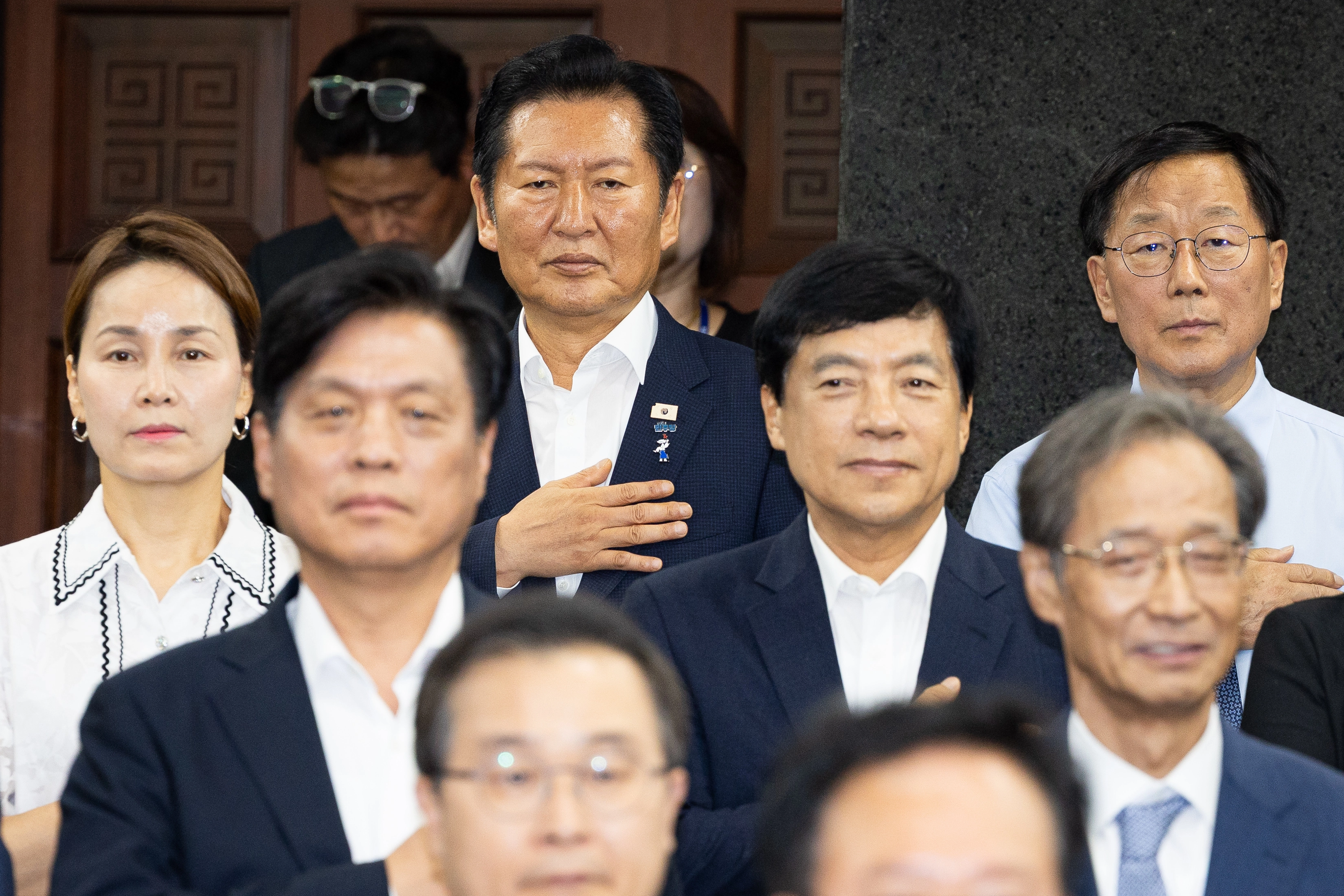 국민의례 하는 정청래·이성윤  더불어민주당 당권주자인 정청래 전 대표를 비롯한 의원들이 지난 14일 국회에서 열린 의원총회에서 국민의례를 하고 있다.