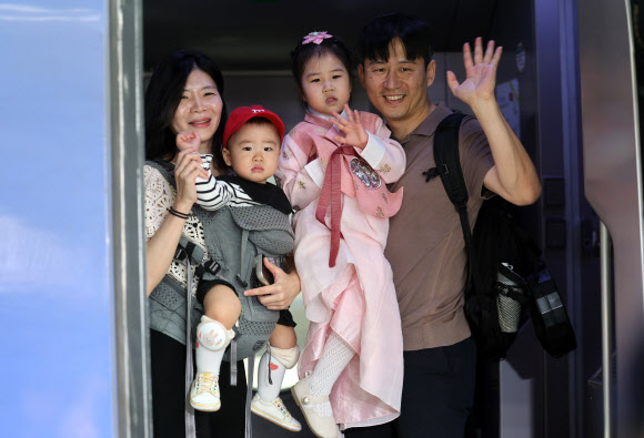추석을 앞둔 23일 서울역에서 한 가족이 열차에 탑승하며 인사하고 있다. 2026.9.23 연합뉴스