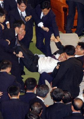 지난 12일 오전 국회 본회의에서 야당의 탄핵안 가결을 저지하던 송영길 열린우리당 의원이 국회 경위들에 의해 들려 나가고 있다. 서울신문 포토라이브러리