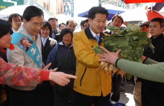 열린우리당 정동영 의장이 5일 부산 수영구 팔도시장을 방문해 상인에게 채소를 구입하고 있다. 남상인기자 sanginn@