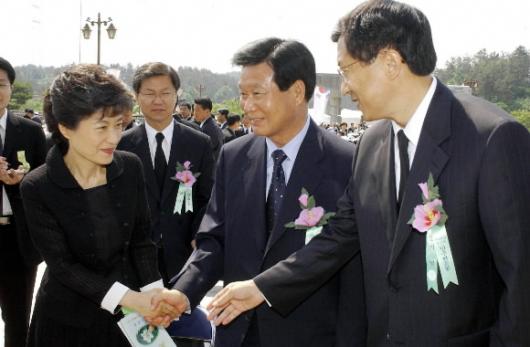지난 18일 5·18 민주화운동 기념식에 참석한 박근혜 한나라당대표와 한화갑민주당대표, 신기남 우리당의장이 악수를 나누고 있다. 청와대사진기자단
