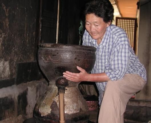 붉은 빛 아름다운 술 '진도 홍주'의 맥을 잇고 있는 허화자씨가 고조리를 불에 얹고 있다.