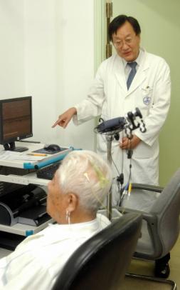 김영설 박사가 뉴로피드백 시스템으로 환자를 치료하면서 얘기를 나누고 있다.