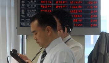 원·달러 환율 980선이 무너진 9일 서울 외환은행 본점에서 외환 딜러들이 굳은 표정으로 바쁘게 움직이고 있다. 안주영기자 jya@seoul.co.kr