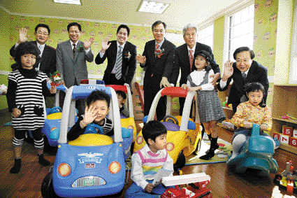 지난 10월 광주광역시에서 오픈한 희망장난감도서관 개점 행사에서 정용진(뒷줄 왼쪽에서 세번째) 신세계 부회장을 비롯한 신세계 및 광주시 관계자들이 어린이들과 포즈를 취하고 있다. 신세계 제공