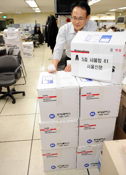 11일 서울 중구 태평로1가 서울신문사 편집국에서 한 기자가 국정홍보처에서 보낸 기사송고실의 개인물품을 확인하며 허탈해하고 있다. 안주영기자 jya@seoul.co.kr