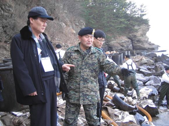 태안 생태 복원 연구를 위해 현지를 방문한 서울대 교수단의 강태진(맨왼쪽) 공대 학장이 19일 충남 태안 구릉포에서 원흥규 7공수특전여단장에게서 방제 작업 상황을 듣고 있다. 태안 서재희기자 s123@seoul.co.kr