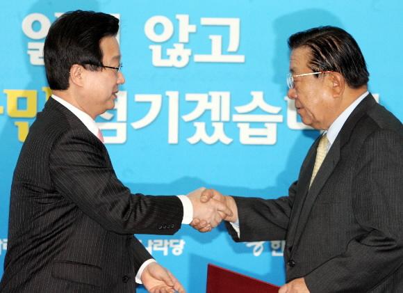 한나라당 강재섭(왼쪽) 대표가 25일 오전 여의도 당사에서 안강민 공천심사위원장에게 임명장을 수여하고 있다. 이언탁기자 utl@seoul.co.kr