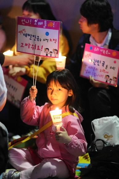 2008년의 6월 지난 5일 서울광장에서 열린 미국산 쇠고기 수입반대 촛불집회에 참가한 한 어린이가 촛불과 피켓을 들고 있다. 서울신문 포토라이브러리