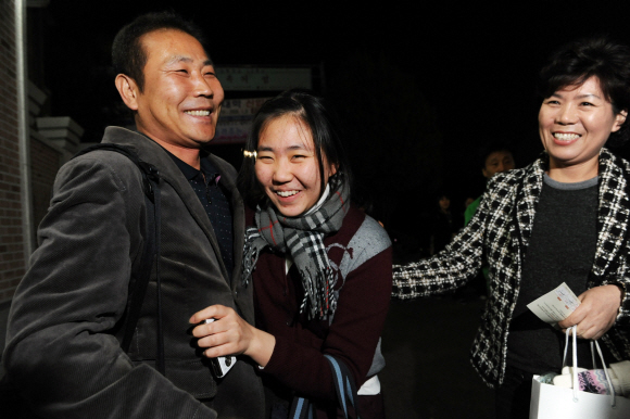 후련한 가족  13일 서울 배화여고에서 대학수학능력시험을 치른 한 수험생이 교문 밖에서 기다리던 아버지 품에 환한 표정으로 안기고 있다. 도준석기자 pado@seoul.co.kr
