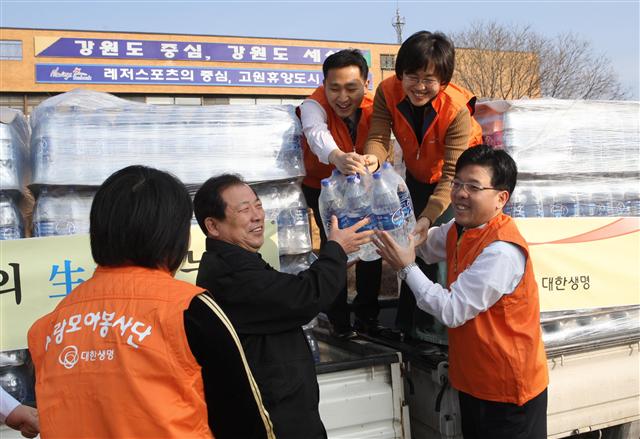 지난달 6일 강원도 태백시청 앞에서 열린 ‘사랑의 생수 전달식’에서 대한생명 직원들이 지원할 생수를 내려놓고 있다. 겨울 가뭄 때문에 태백시가 전날인 5일 전국 각급기관에 물지원을 요청하자 대한생명 봉사단이 다음날 오전 10시 바로 생수를 제공했다.  대한생명 제공