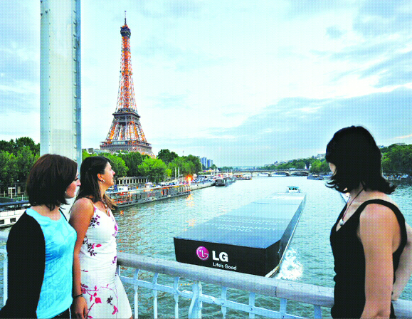 프랑스 사람들이 센강 위에서 LG전자가 617ℓ급 양문형 냉장고 신제품을 알리기 위해 냉장고 모양으로 만든 컨테이너선을 바라보고 있다. LG전자 제공
