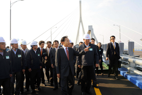 이명박(앞줄 왼쪽) 대통령이 16일 인천 영종도 인천대교 개통식에 참석한 뒤 공사 관계자들을 격려하며 다리 위를 걷고 있다. 최해국기자 seaworld@seoul.co.kr