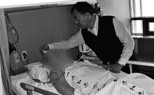 김 할머니의 맏사위 심치성(오른쪽)씨가 13일 김 할머니의 상태를 확인하고 있다.