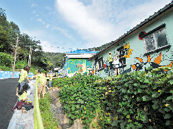 금호건설의 후원을 받은 대학생들이 서울 홍제동 개미마을에서 예쁜 벽화를 그리고 있다. 금호건설 제공