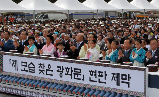 이명박 대통령 내외를 비롯한 내외귀빈들이 15일 광화문 현판 제막 버튼을 누른 뒤 박수를 치고 있다. 연합뉴스