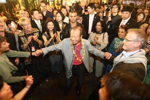 지난 12일 밤 부산 광안리 카페에서 열린 ‘퇴임 파티’에서 김동호(가운데) 부산국제영화제 위원장이 국내외 영화인들과 손에 손을 잡은 채 춤을 추고 있다.  부산국제영화제 제공
