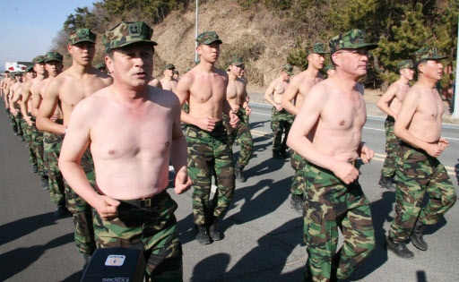 해군 특수전여단(UDT)이 1일 진해 앞바다에서 실시한 혹한기 훈련에 참가한 해군 장성들(앞줄)이 웃통을 벗은 채 ‘알통 구보’를 하고 있다. 앞줄 왼쪽부터 윤재갑 소장, 방금철 준장, 김판규 준장. 창원 연합뉴스