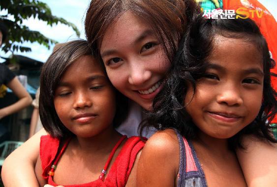 탤런트 이지아(가운데)가 필리핀의 빈민 도시 말라본에서 봉사활동을 펼친 뒤 현지 어린이들과 사진을 찍고 있다.  서울신문STV 제공 