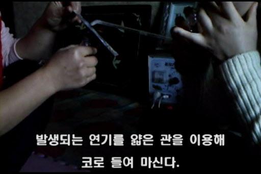 지난해 12월 탈북자단체인 ‘NK지식인연대’가 북한 주민들로부터 입수, 공개한 히로뽕을 흡입하는 북한 주민 동영상. 연합뉴스