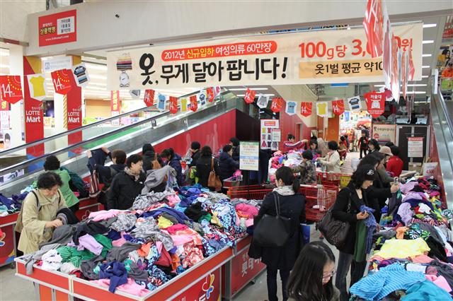 13일 롯데마트 서울역점의 ‘옷 무게 달아 팝니다’ 현수막이 내걸린 행사장이 퇴근길 직장인, 장을 보러 나온 주부 등 고객들로 붐비고 있다.  롯데마트 제공