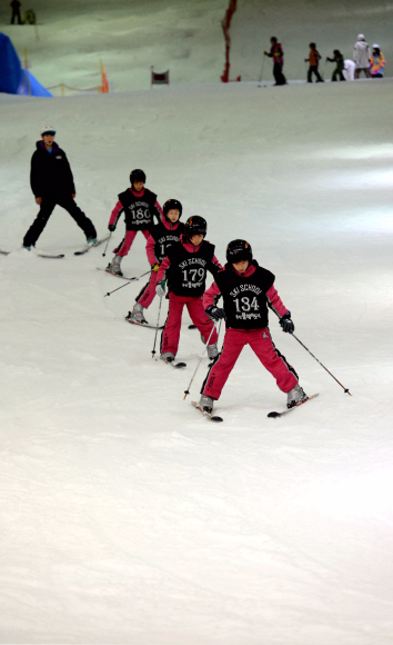 웅진플레이도시 실내스키장에서 어린이들이 스키 타는 법을 배우고 있다.
