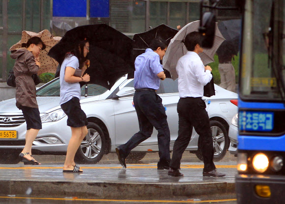 제15호 태풍 ‘볼라벤(BOLAVEN)’이 북상하는 가운데 28일 오전 서울 광화문 광장 인근도로에서 시민들이 발걸음을 옮기고 있다. 연합뉴스