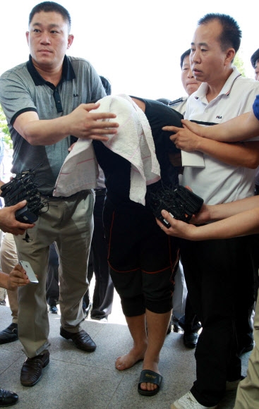 전남 나주의 7세 어린이 성폭행 사건의 용의자 고종석이 31일 경찰에 붙잡혀 수사본부가 꾸려진 나주경찰서로 압송되고 있다.