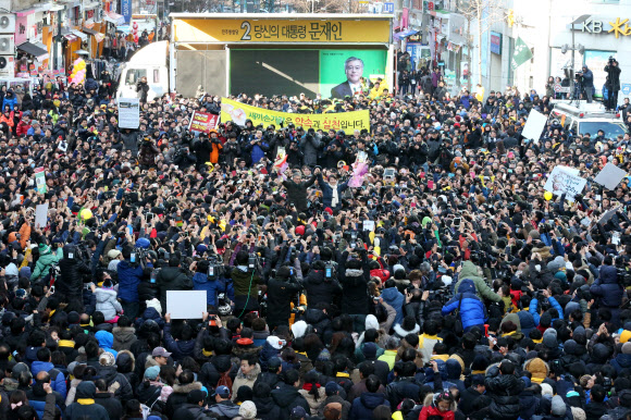 민주통합당 문재인 대선후보와 안철수 전 후보가 9일 경기도 군포시 산본역 앞에서 열린 집중유세에서 손을 들어 지지자들에게 답례하고 있다. 연합뉴스