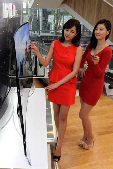 29일 서울 영등포구 여의도 LG전자 본사에서 도우미들이 세계 최초로 출시된 곡면 올레드 TV를 소개하고 있다. 연합뉴스