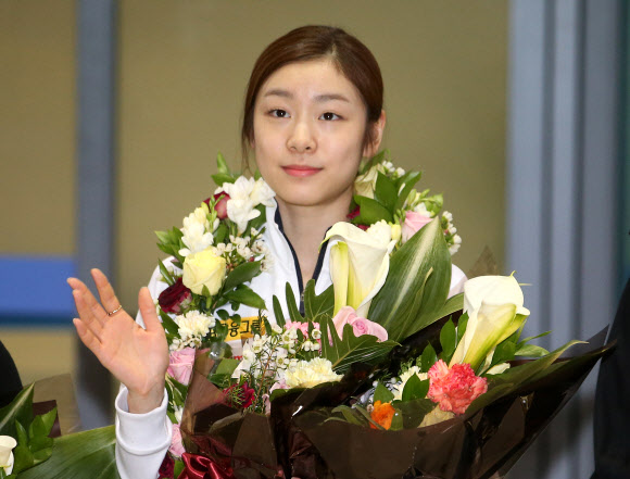 2013 국제빙상경기연맹(ISU) 세계선수권대회에서 우승한 ‘피겨 여왕’ 김연아가 20일 오후 인천국제공항을 통해 귀국하며 손을 흔들고 있다.  연합뉴스