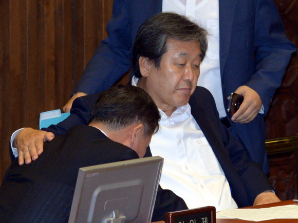 김무성(가운데) 새누리당 의원이 고개를 푹 숙인 채 앉아 있는 김재원(왼쪽) 당 전략기획본부장의 등을 다독이고 있다. 이호정 기자 hojeong@seoul.co.kr