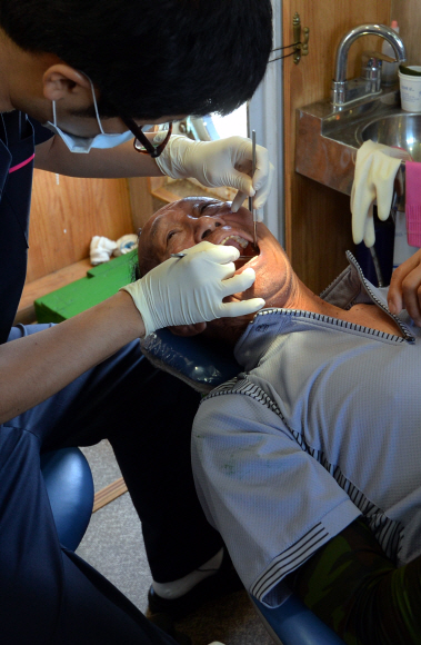 치과 공중보건의가 섬주민의 치아 상태를 확인하고 있다.
