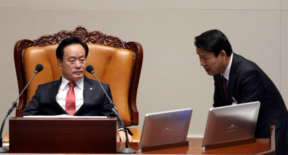 이병석 국회부의장(왼쪽)이 19일 오전 국회 본회의 대정부질문을 앞두고 관계자에게 민주당의 본회의 참석여부를 듣고 있다. 이날 대정부질문은 민주당 의원들이 제시간에 참석하지 않아 개회가 지연됐다.  연합뉴스