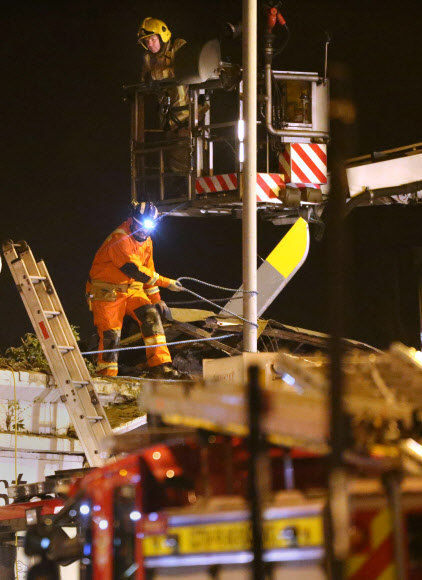 영국 스코틀랜드 글래스고 시내의 한 술집에 경찰 헬기가 추락한 가운데 지난달 30일(현지시간) 구조대원들이 건물 잔해에서 실종자 수색 작업을 하고 있다. 글래스고 AP 연합뉴스