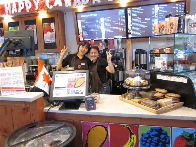 캐나다 워킹홀리데이에 참가한 박가연(왼쪽)씨가 현지의 커피 전문점에서 일을 하던 중 캐나다인 동료와 포즈를 취하고 있다. 캐나다에서는 국제행사 등에서 자원봉사 활동을 하거나 서비스업에 종사할 기회가 많다.  외교부 제공