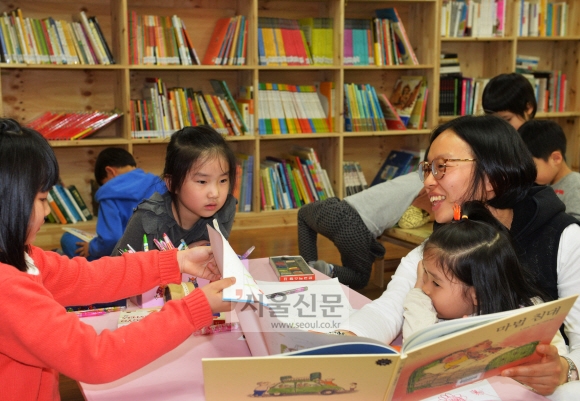 4일 서울 영등포구 대림동 ‘언니네작은도서관’에서 부모와 함께 도서관을 찾은 아이들이 책을 읽으며 즐거워하고 있다. 주민들의 사랑방 역할을 하는 이 도서관은 마을 공동체의 거점 공간으로 자리 잡았다. 박윤슬 기자 seul@seoul.co.kr