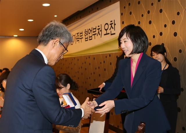 조윤선(오른쪽) 여성가족부 장관이 16일 정부서울청사에서 열린 ‘협업부처 간담회’에서 장석철 고용노동부 직업능력정책과 서기관에게 감사패를 전달하고 있다. 감사패에는 ‘우리가 맞잡은 두 손이 굳건해질수록 국민께 보다 가까이 다가갈 것입니다’라고 적혀 있다.  여성가족부 제공