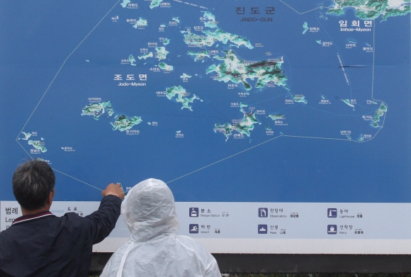 세월호 침몰사고 29일째인 14일 오후 전남 진도군 팽목항을 찾은 단원고 학생 유가족(오른쪽)이 안내도를 보며 사고 해역을 찾아보고 있다.  박지환기자 popocar@seoul.co.kr