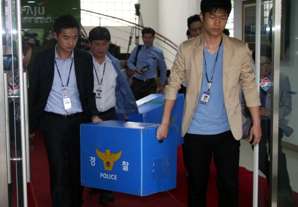 경찰이 2일 파주시청 시정지원관실 등 2곳을 압수수색한 뒤 압수물을 옮기고 있다. 연합뉴스