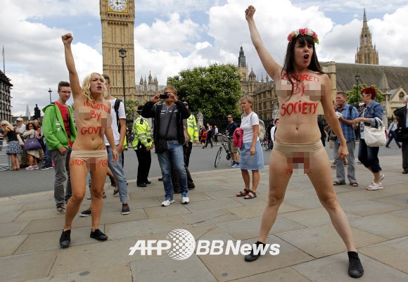 7일(현지시간) 영국 런던 중심부 국회의사당 앞 광장에서 우크라이나 여성 인권단체 피멘(femen) 회원들이 상의를 탈의한 채 여성할례(FGM)를 반대하는 반누드시위를 벌이고 있다.  ⓒ AFPBBNews=News1
