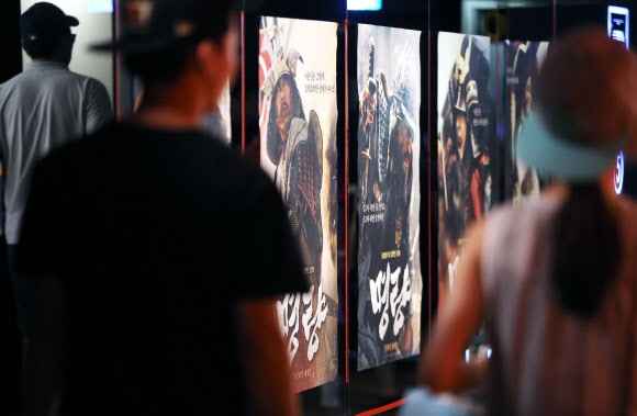 영화 ’명량’이 개봉 첫날 68만 명의 관객을 끌어모으며 역대 개봉 영화 중 최고의 오프닝 성적을 올린 가운데 31일 오후 시민이 ’명량’을 관람하기 위해 서울시내 한 극장 상영관으로 들어서고 있다.  연합뉴스