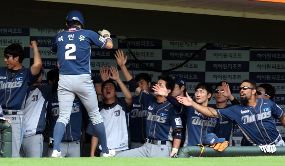 전날 조명탑 고장으로 경기가 중단됐던 롯데 자이언츠와엔씨 다이노스의 프로야구 경기가 열린 6일 부산 사직야구장. 5회말 득점한 엔씨 박민우가 덕아웃에서 선수들의 축하를 받고 있다.  연합뉴스