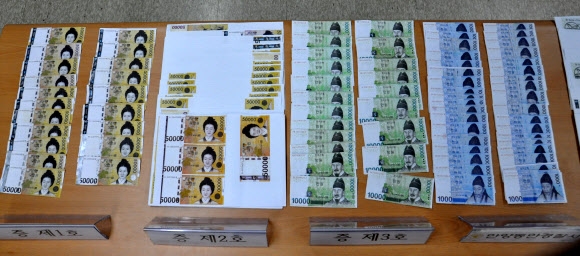 안양동안경찰서는 19일 컬러복합기를 이용, 지폐를 위조해 사용한 혐의(통화위조)로 조모(47)씨를 구속했다. 사진은 경찰이 압수한 증거물. 안양동안서 제공