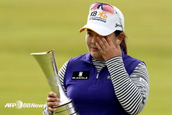 South Korea’s Park Inbee wipes away a tear as she celebrates her victory with the trophy after her final round 65, on day four of the Women’s British Open Golf Championships in Turnberry, Scotland, on August 2, 2015.